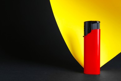 Photo of Stylish small pocket lighter on color background, space for text