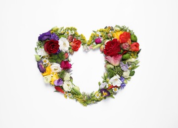 Photo of Beautiful heart made of different flowers on white background, top view