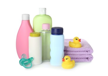 Bottles of baby cosmetic products, towels, pacifier and rubber ducks on white background