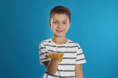 Photo of Little boy with slime on blue background