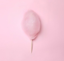Photo of Sweet cotton candy on pink background, top view