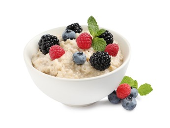 Tasty oatmeal porridge with blackberries, raspberries and blueberries in bowl on white background