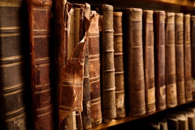 Collection of old books on shelf in library, closeup