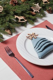 Photo of Luxury festive place setting with beautiful decor for Christmas dinner on white wooden table