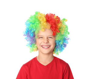 Little boy in clown wig on white background. April fool's day