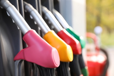 Photo of Petrol pump filling nozzles at gas station, closeup