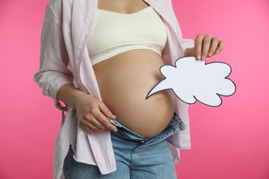 Pregnant woman with empty paper thought cloud on pink background, closeup. Choosing baby name