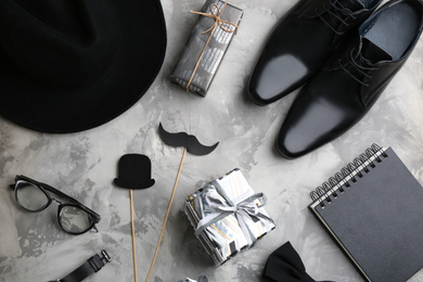 Flat lay composition male accessories and gift boxes on light grey stone background. Happy Father's day