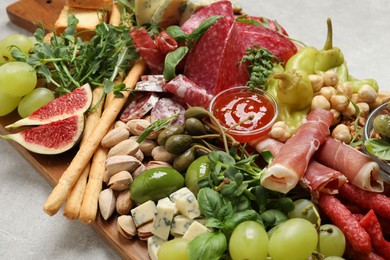 Photo of Set of different delicious appetizers served on light grey table, closeup