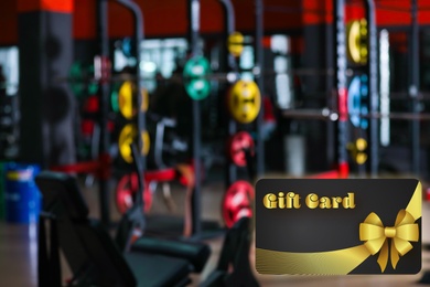 Image of Gym gift card. Blurred view of health club with modern equipment