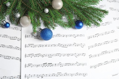 Flat lay composition with Christmas decorations on music sheets