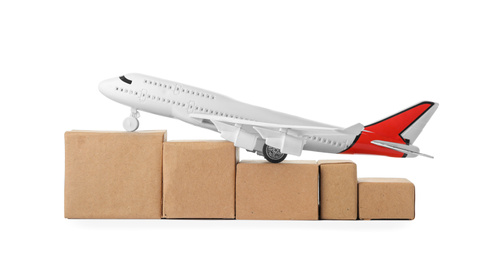 Toy plane with boxes isolated on white. Logistics and wholesale concept