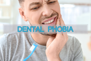 Dental phobia concept. Man suffering from toothache indoors