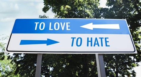 Road sign with different directions - TO HATE or TO LOVE outdoors