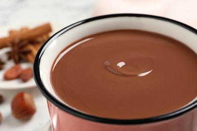 Yummy hot chocolate in mug on table, closeup