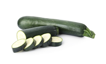 Cut and whole green ripe zucchini isolated on white
