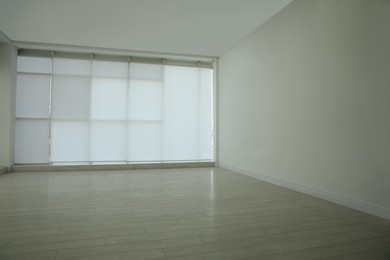 Empty room with panoramic windows and white wooden floor