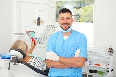 Professional dentist and patient in modern clinic