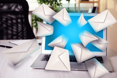 Image of Email spam. Workplace with laptop and many letters