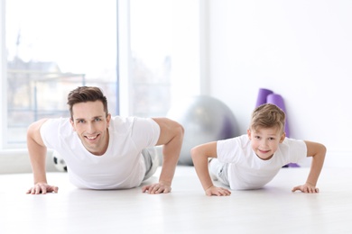 Dad and his son training in gym