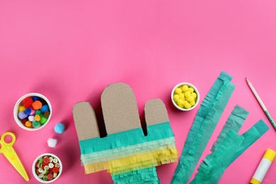 Cardboard cactus and materials on pink background, flat lay. Pinata DIY