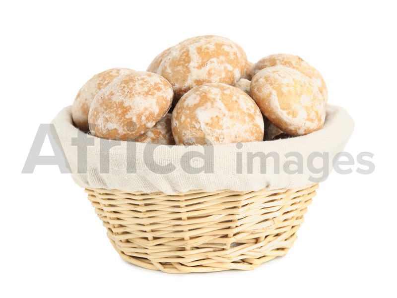 Photo of Tasty homemade gingerbread cookies in wicker basket on white background