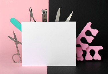 Photo of Set of manicure tools and blank card on color background. Space for text