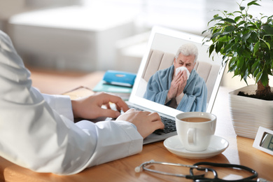 Doctor consulting sick patient online by video chat in medical office, closeup