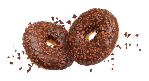 Image of Sweet delicious donuts falling on white background