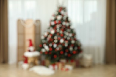 Blurred view of room interior with beautifully decorated Christmas tree