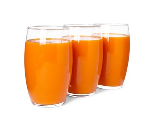 Photo of Three glasses of fresh carrot juice on white background