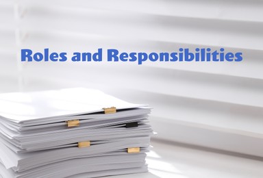 Roles and Responsibilities concept. Stack of paper on window sill indoors