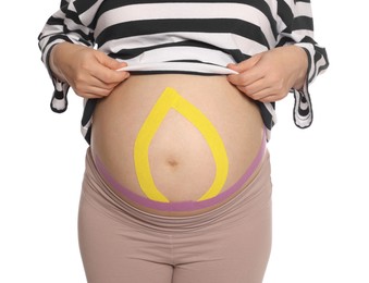 Photo of Pregnant woman with kinesio tapes on her belly against white background, closeup