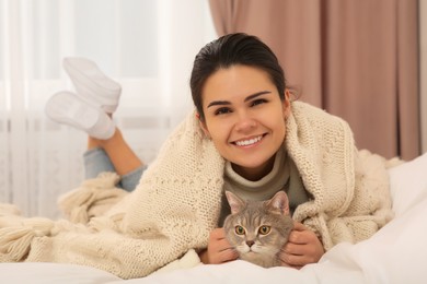 Photo of Young woman with adorable cat at home