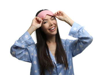 Beautiful Asian woman wearing pajamas and sleeping mask on white background. Bedtime