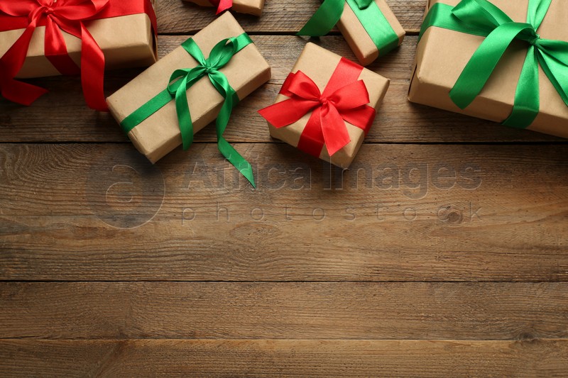 Many gift boxes on wooden table, flat lay. Space for text