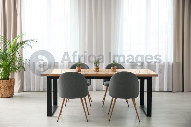 Photo of Modern room interior with chairs and table