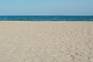Beautiful view of sandy beach near sea on sunny day