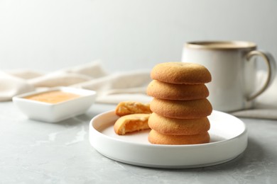 Photo of Tasty shortbread cookies with filling on light grey marble table
