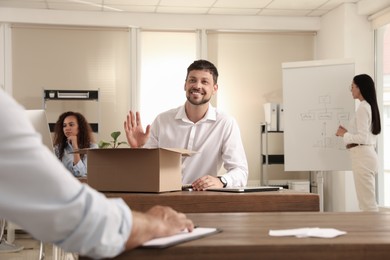 Photo of New coworker greeting employee in modern office