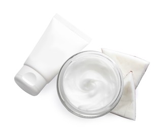 Different hand care cosmetic products and coconut pieces on white background, top view