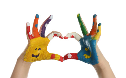 Kid with smiling faces drawn on palms showing heart gesture against white background, closeup