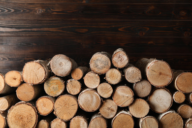 Cut firewood on wooden background. Heating in winter