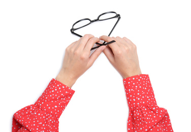 Woman holding eyeglasses on white background, top view
