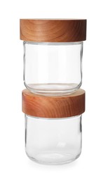 Photo of Two empty glass jars with wooden lids isolated on white