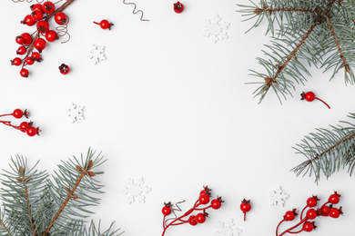 Winter composition with decorative branches and fir tree on white background, top view
