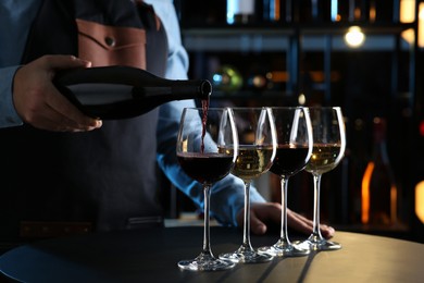 Bartender preparing wine tasting set at table indoors, closeup
