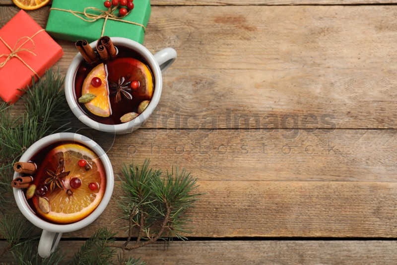 Flat lay composition with tasty mulled wine on wooden table. Space for text