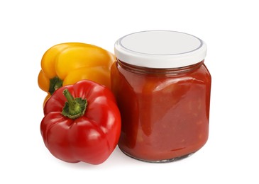 Glass jar of delicious canned lecho and fresh bell peppers on white background