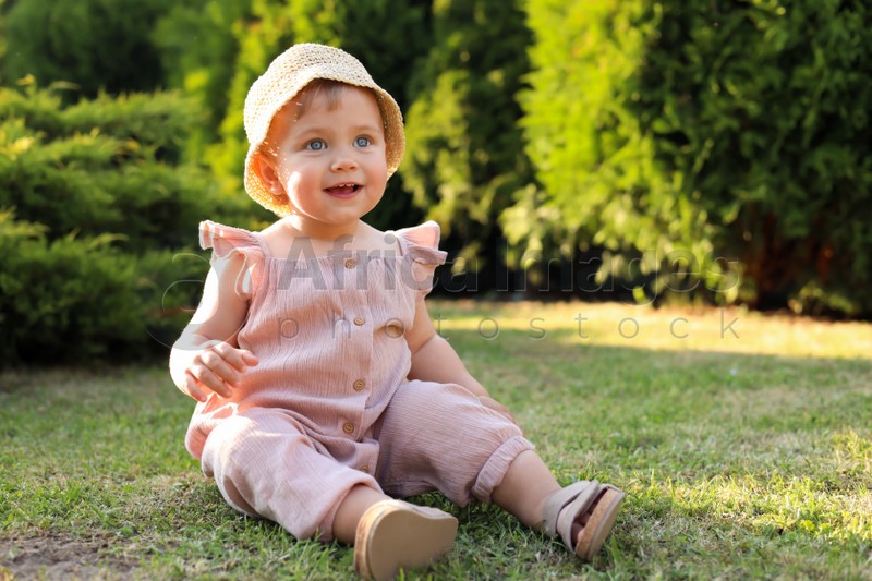 Cute little girl wearing stylish clothes outdoors on sunny day